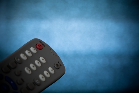 Close up shot of a remote control with out of focus tv static.の写真素材