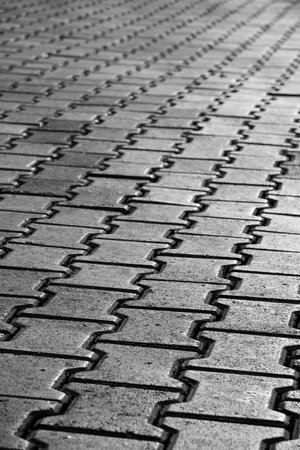 Black & White photo of a pavement pattern. Selective focus.
