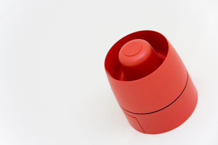 Fire alarm on white wall with copy space. 