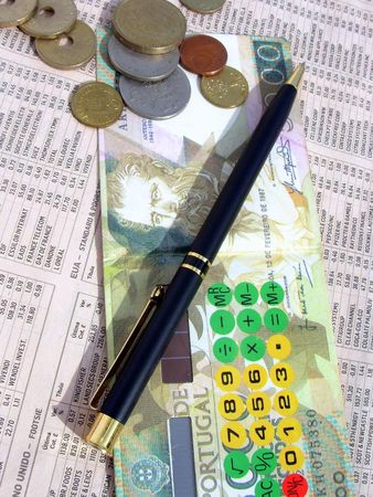 Calculator and pencil on a financial Journal "Investing" page.の写真素材
