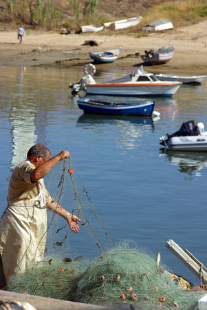 Old fisherman prepares the nets.の写真素材