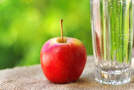  	Red apple and glass of water.の写真素材