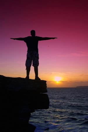 Young man looking at sunset.の写真素材