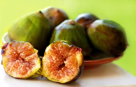 Ripe fruits of a fig on green background の写真素材