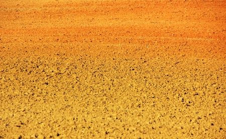 Ploughed red clay soil の写真素材