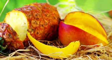 Pineapple and mango on tableの写真素材