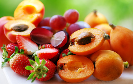 sliced  medlar and strawberries fruitsの写真素材