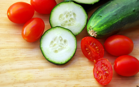 cucumber and tomatoes on tableの写真素材