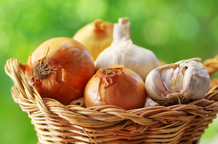 garlic and onion in basketの写真素材