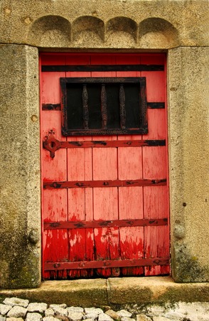 old red wooden door at Portugalの写真素材