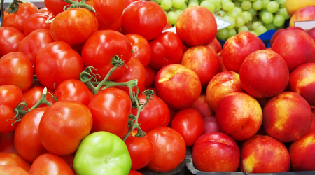 Fresh tomatoes & peaches in marketの写真素材