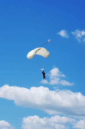 Skydiver on blue and white parachuteの写真素材