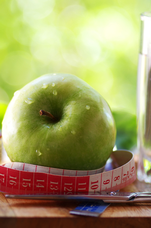 measuring tape,green apple and scissorsの写真素材