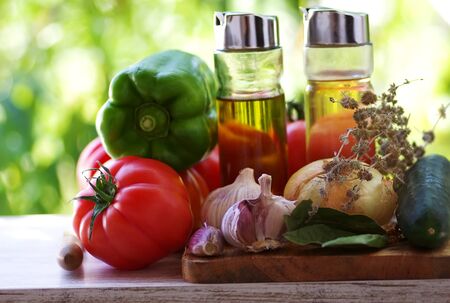 vegetables and olive oil on wooden tableの写真素材