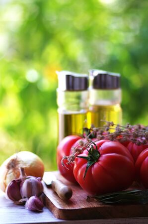vegetables and olive oil on wooden tableの写真素材