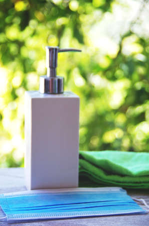 blue face mask and antibacterial gel sanitizer to prevent coronavirus Covid 19の写真素材