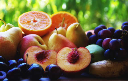 sliced peaches and pears, grapes and cherry fruitsの写真素材