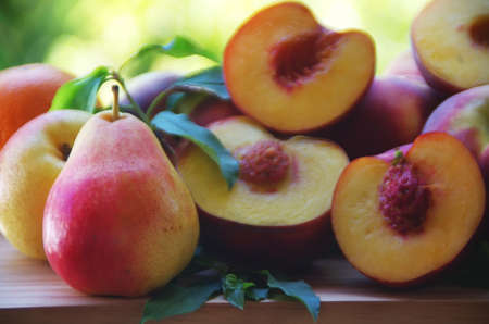 Fresh Pears And Peaches On Wooden Tableの写真素材