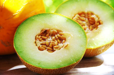 Fresh cantaloupe melon cut, sliced in halfの写真素材