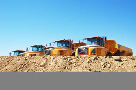 yellow dump trucks on parking near quarryの写真素材