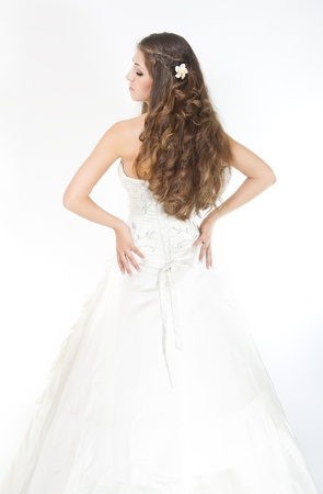 Long curly hair. Bride with hairstyle in wedding dress. Back view. Over whiteの写真素材