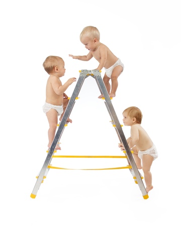 group of babies climbing on stepladder over white background	の写真素材