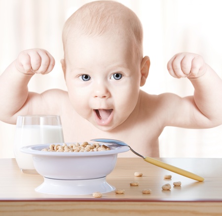 Happy baby meal: cereal and milk. Concept: healthy food makes child strong and healthの写真素材