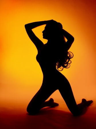 woman sexy silhouette over orange backgroundの写真素材