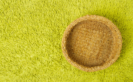 Basket empty over green carpet background