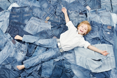 Happy child on jeans background. Denim fashionの写真素材