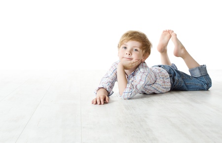 Child lying down on floor and looking at cameraの写真素材