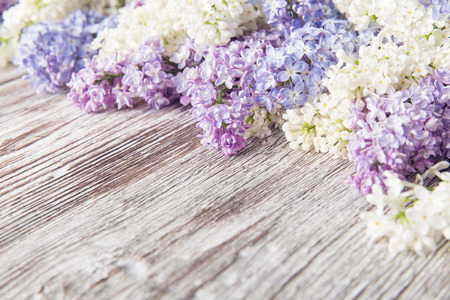 lilac flowers on wood background, blossom branch on vintage wooden textureの写真素材