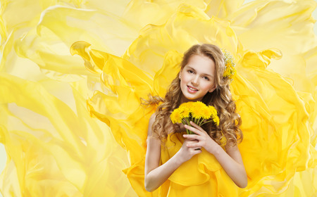 Woman and Yellow Flowers Bouquet, Young Model Makeup Portrait and Dandelion, Flying Fabricの写真素材