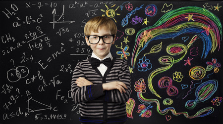 Kid Creativity Education Concept, Child Learning Art Mathematics Formula, School Boy Ideas on Black Chalk Boardの写真素材