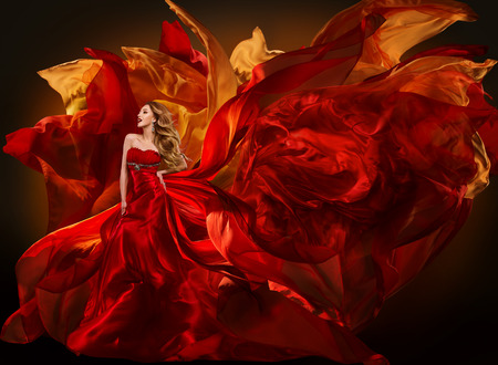 Woman Fashion Dress Flying Red Fabric, Beautiful Girl Waving Silk Cloth on Windの写真素材