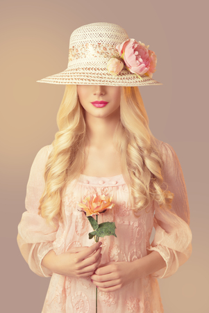 Woman in Fashion Straw Hat Holding Peony Flower, Young Girl in Pink Dress, Long Curly Hair, Unrecognizable Faceの写真素材