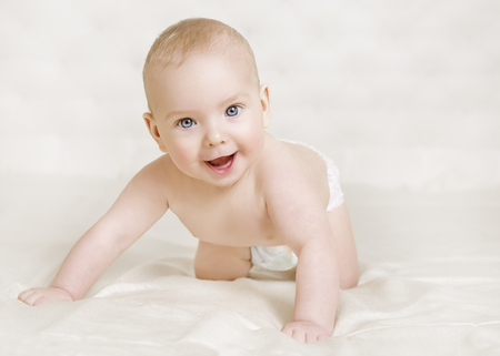 Baby Crawling, Happy Kid Boy in Diaper Crawl over White Bed, Smiling Five Months Childの写真素材