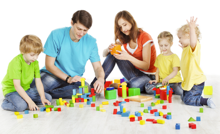 Family and Kids Playing Building Blocks, Parents with Children Play Toys, two Parent three Child over White Backgroundの写真素材