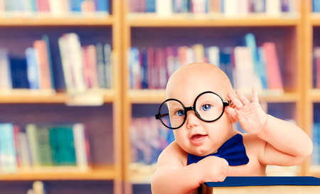 Smart Baby in Glasses with Book, Little Child in School Library, Children Early Education and Developmentの写真素材