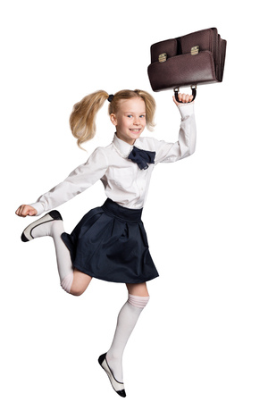 Child Running Back to School, Girl Isolated over White Background, Happy Kid in Schools Uniform with Briefcase Bagの写真素材