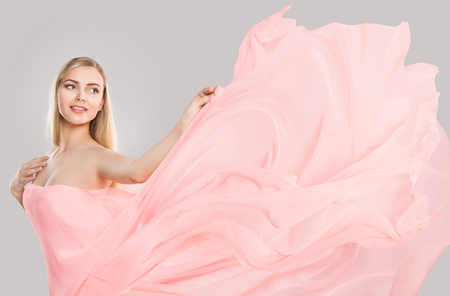 Fashion Model Pink Flying Waving Silk Fabric, Woman Beauty Portrait over White Backgroundの写真素材