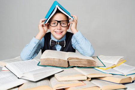 Happy Child Reading Many Books with Book on Head, Funny School Boy in Glasses, Easy Education