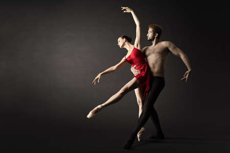 Ballet Dancers. Modern Ballerina Couple Posing over Gray Backgroundの写真素材