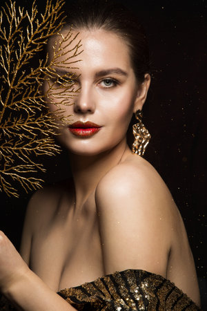 Luxury Woman Portrait with Gold Jewelry. Mystery Girl hiding Face. Glitter Make up. Elegant Lady...