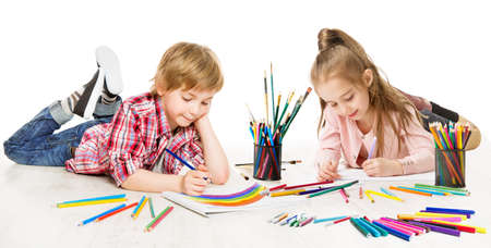 Kids Drawing and Painting. Child Creative Development. Preschooler Children Education and Active Playing lying down over White Backgroundの写真素材