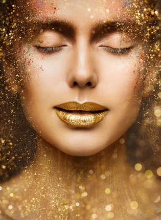 Gold Lip Gloss Make up Closeup. Beauty Model Face Portrait with Closed Eyes and Golden Sparkles on Skin. Luxury Woman Skin Careの写真素材