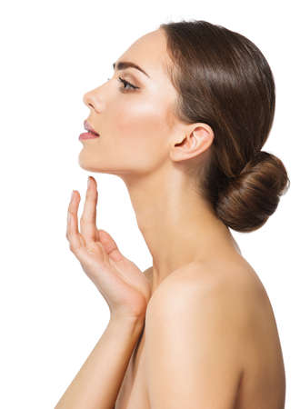 Woman Face Profile. Perfect Women Nose Side view. Facial Model showing with Finger on Slim Chin and Neck. Facelift Massage and Plastic Surgery Concept over White isolatedの写真素材