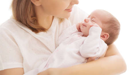 Sleeping Newborn Baby in Mother Hands. Mum Holding One Month Old Child over White. Woman hugging resting Infant Kid. Childcare and Happy Motherhoodの写真素材