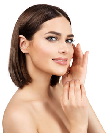 Beauty Woman Face Skin Care. Smiling Model with Perfect Natural Make up and Hands on Cheeks looking at camera isolated White. Women Manicure and Facial Treatment Cosmetics. Spa Massage and Face Lift Cosmetologyの写真素材