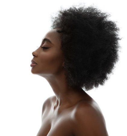 Face Profile of African Beauty Woman with Afro Hairstyle. Dark Skinned Model Side view Portrait over White Background. Women Facial and Body Care Spa Cosmetology Cosmeticsの写真素材
